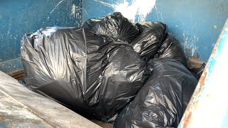 Small Compactor and black bags - Slowmotion (Full HD)