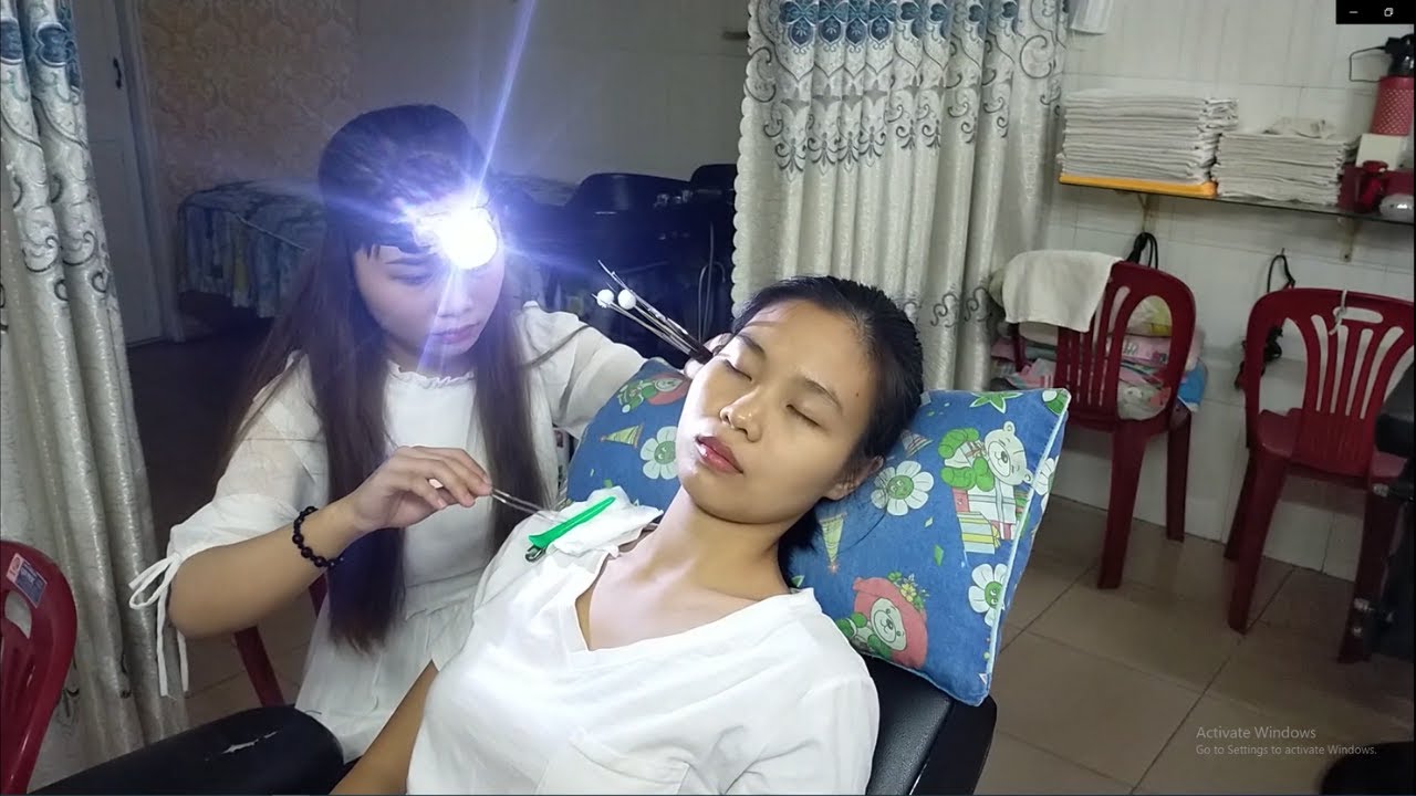 Beautiful Girl in Vietnam Earwax Removal Relax Ears for