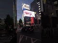 Au watching 3D Cat billboard in Shinjuku, 2025