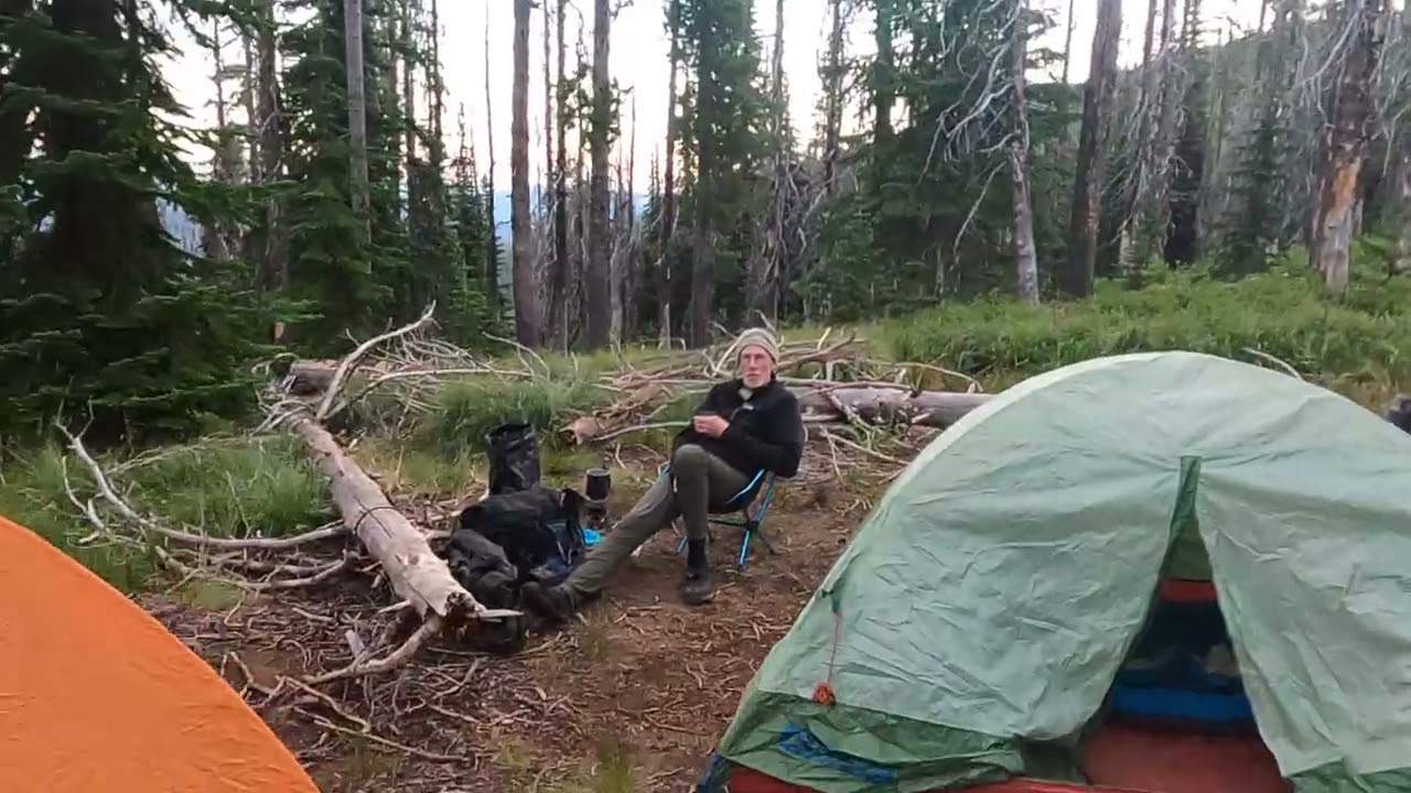 GX0110041-IDBDR-'25-"Smoking Place " kiosk campground- late afternoon roadside camp amongst the logs