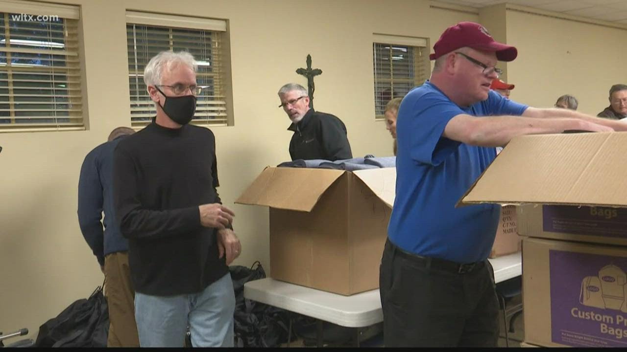 Volunteers pack supply bags for homeless