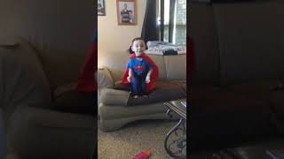 Superman kid jumps off couch