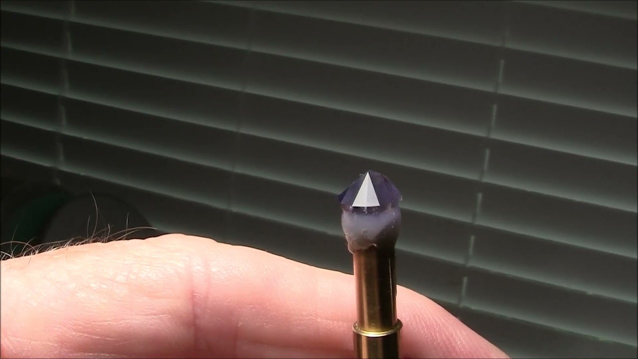 Faceting an iolite  gemstone.