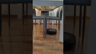 Roomba i5+ cleaning underneath a kitchen table