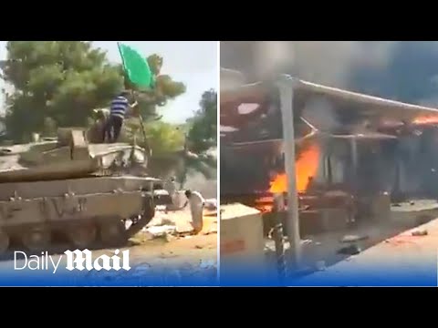 Hamas fighters capture Israeli tanks and loot equipment after attack on border post