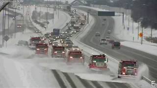 Group of trucks plowing Minnesota highway