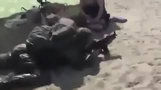 Soldier on beach with The Rolling Stones paint it black playing
