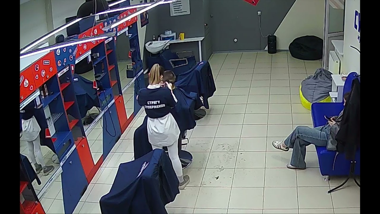 Girlfriend watches as barberette buzzes her boyfriend's hair