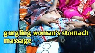 Massage the stomach of a woman who feels bloated and nauseous