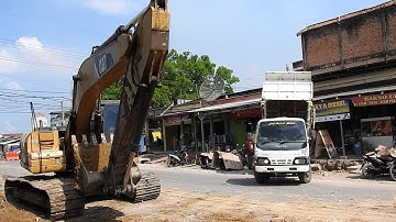 Dump Truck Isuzu and Excavator Cat 320D Working Loading and Unloading Soil for Road Contructions
