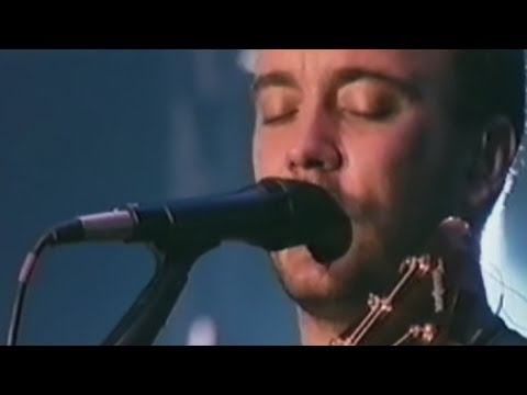 Dave Matthews Band Performs Grey Street at Giants Stadium on 7/12/00. Prior to '01 Grey Street had an extra verse and chorus. This is similar to the LWS version. Grey Street was later truncated and recorded for Busted Stuff. Dave also recovers from a broken string midway through... Lyrics from DMBAlmanac.com: Oh just look at how she listen but she says nothing of what she thinks oh, she just listens to the same old thing running out onto Grey Street she says, he how did I come to this oh, it labors on my life I'm in this emptiness But then the rocks in her heart fall and she feels the weight of life all the colors mix together to grey to break her out Oh no, [?] indifference she prays to God most every night although she swears he doesn't listen there's hope in her that he just might and she said, I pray but they fall on deaf ears I'm supposed to take it all myself to get out of this place Then the rocks in her heart fall and she feels both weight and light oh and heaviness floats out of her and she sinks to sign up the sunlight and the colors mix together to grey Oh, loneliness it brings this she notices she'll never try make it real as anything it takes the work out of your courage she said, please there's a crazy man creeping outside my door I live on the corner of Grey Street it's at the end of the world But then the rope from her tightens and the wings can make her fly out of bright light she falls to blackness out of colors both black and white oh man, I've no doubt <b>...</b>