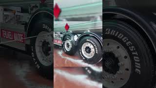 Pressure Washing the Wheels of a Dirty Semi Truck
