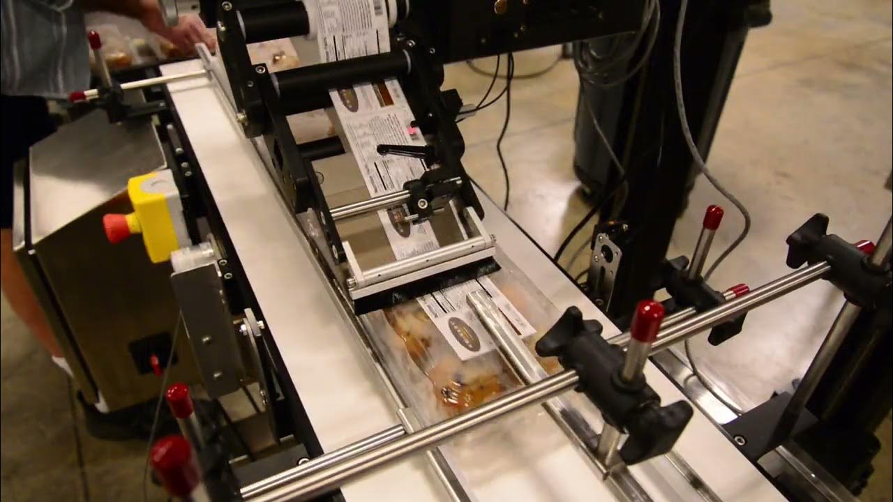 Clam Shell Top/Bottom split belt labeling system with CTM 360A merge