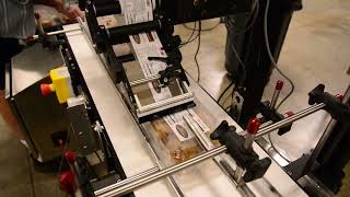 Clam Shell Top/Bottom split belt labeling system with CTM 360A merge label applicators