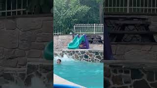 Little boy jumps from top of Little Tikes slide into pool and hits leg on ledge