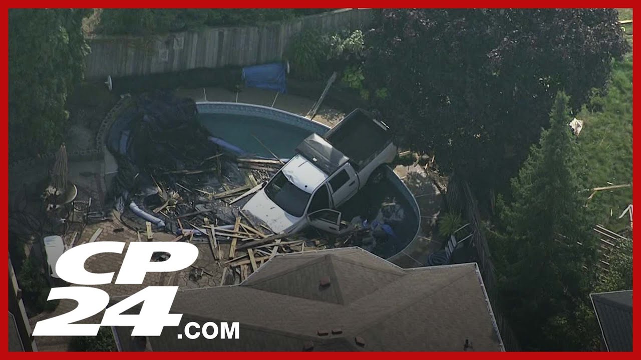 Pedestrian critical after truck crashes through fence in Whitby, lands ...