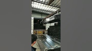 black pipe loading into container