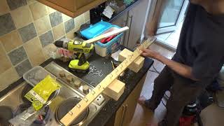 A spare piece of wood and 15 cup hooks