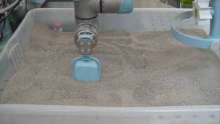 robot arm playing with sand