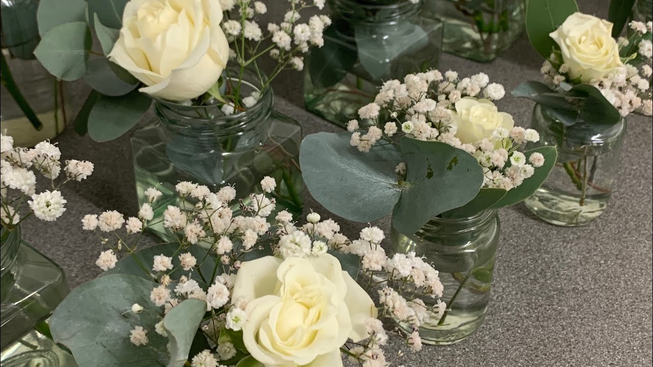Wedding jam jar flowers with roses, eucalyptus and gypsophila