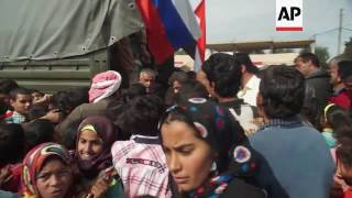 Syrian, Russia troops deliver aid in Syria