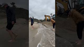 Tractor Digs Trench Connecting River To Ocean