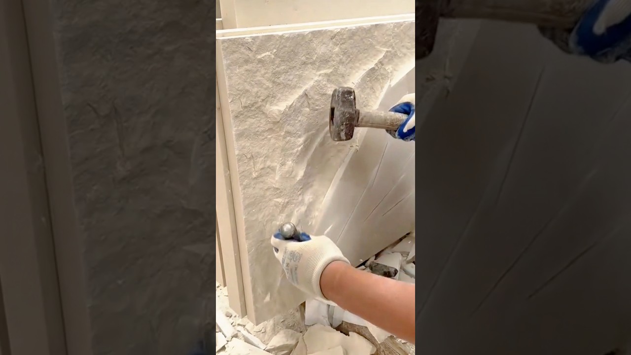 Chiseling rough stone texture to create a handcrafted decorative surface finish