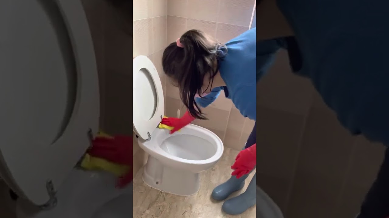 Cleaning the bathroom in rubber gloves and rain boots