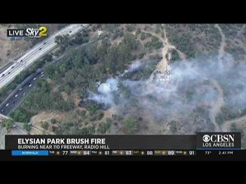 Brush fire burns near Pacific Palisades homes with evacuations underway