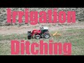 Cleaning out irrigation ditches with the tractor