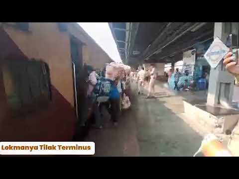 Passengers at Lokmanya Tilak Terminus, Maharashtra, line up to board their train.