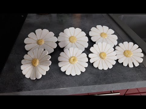 Making daisy flowers out of clay pottery