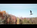 Human drone above the mountain trees