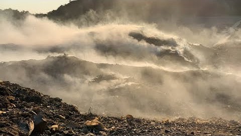 Burning pile of garbage at dump ground stock footage | stock footage | stock video | Cinefootage