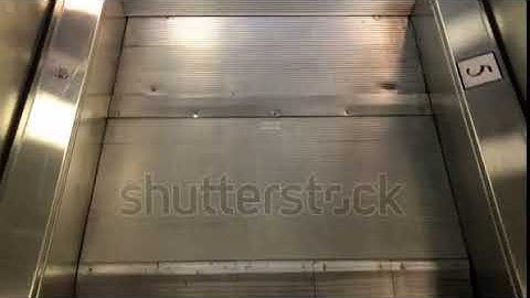 Guy climbs the escalator and goes close up
