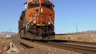BNSF Empty well cars behind a double-header round a curve in the Mojave desert (1 of 2)