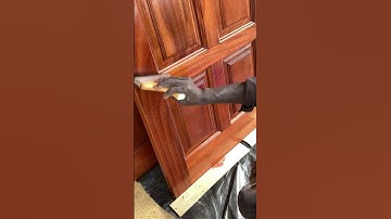 How application of high gloss varnish is done before slow dry on mahogany doors.