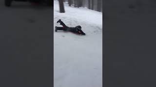 Boy rides sled down snow hill and crashes head first into tree