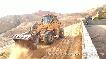 Safety truck unloading soil - Cat Wheel Loader 950B Pushing Spreading Drit