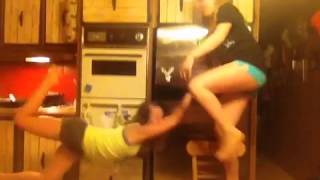 Teen girl falls off chair doing stretch