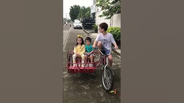 Blake riding a bicycle with sidecar - only in the Philippines