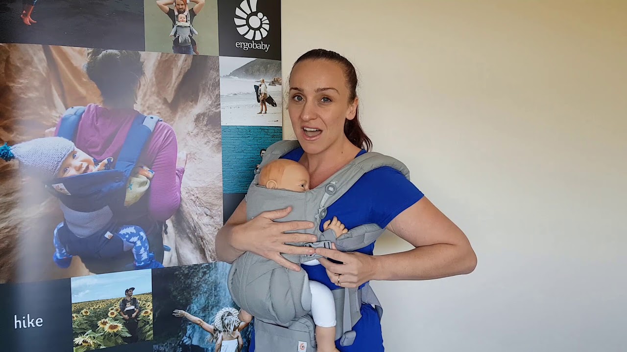 breastfeeding newborn in ergo baby carrier