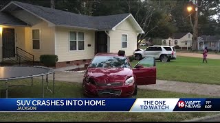SUV crashes into house