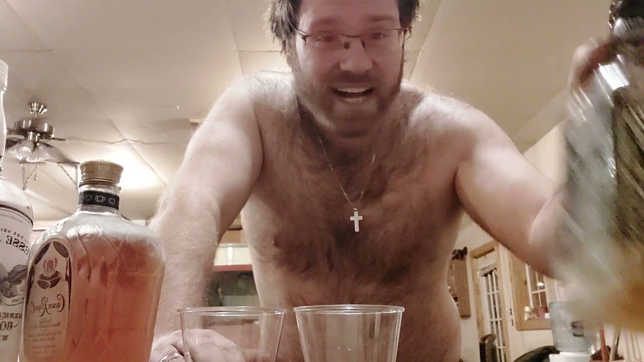 Hairy man reviews whiskey.