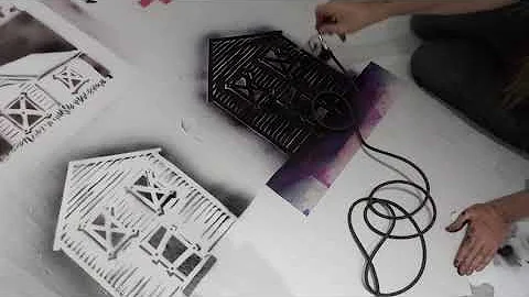 Seth Tobocman painting the floor w/ original street stencils at the Museum of Reclaimed Urban Space