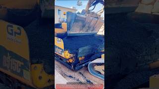 Excavator Machine Loads Hot Asphalt Into Paver During Entrance Work