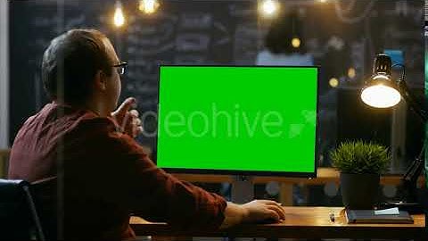 Office Employee at His Desktop Works on a Mock-up Green Screen Personal Computer. | Stock Footage -