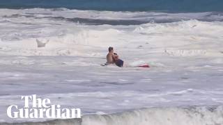 Teen lifeguard struggles to drag boy out of massive waves in California