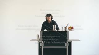 Professinal Bartender Man Juggling Bottles And Shaking Tail At Mobile Bar Table On White