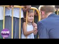 Little girl offers Prince Harry her drawing in Saint Kitts and Nevis